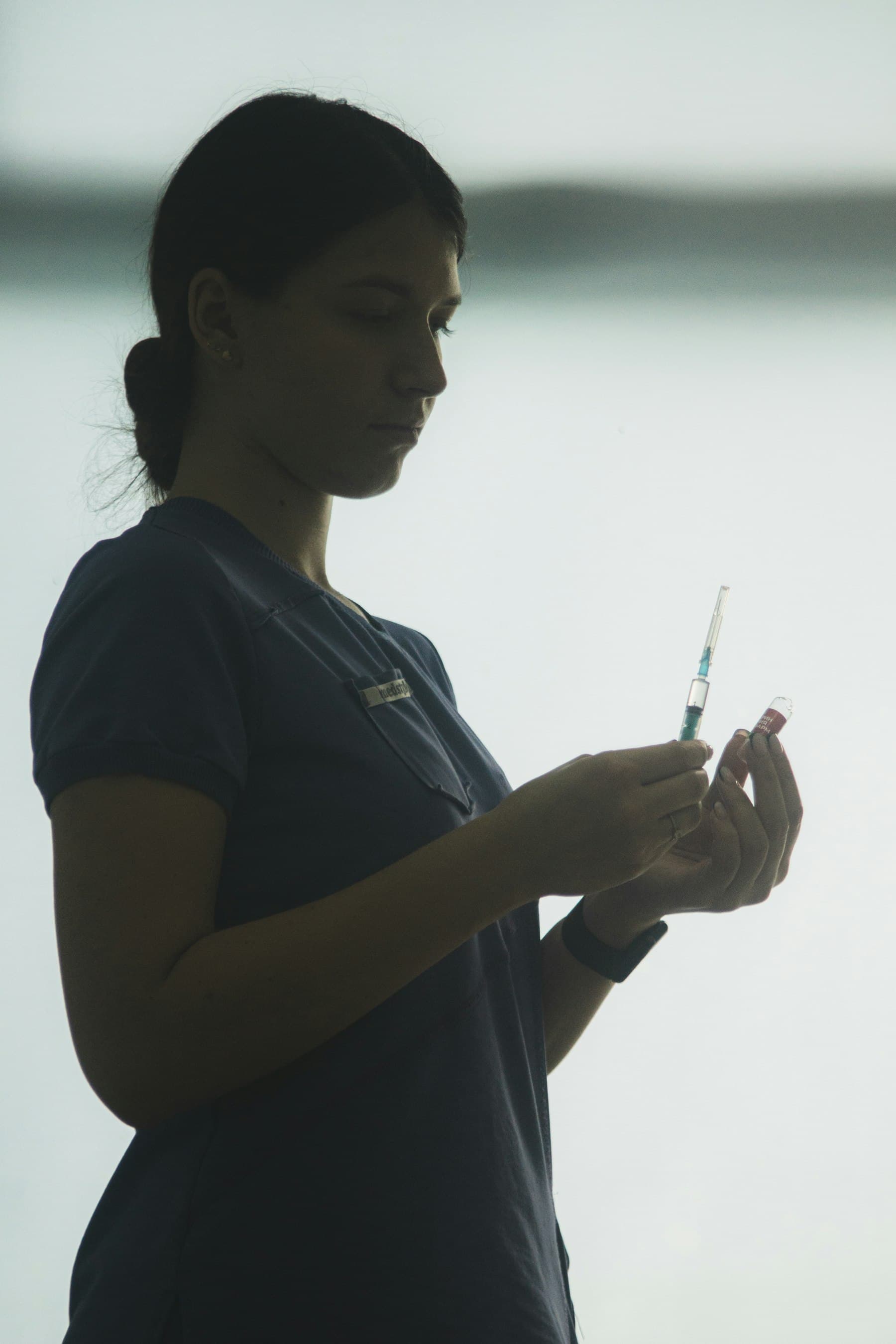 Nurse preparing a syringe for a wellness injection