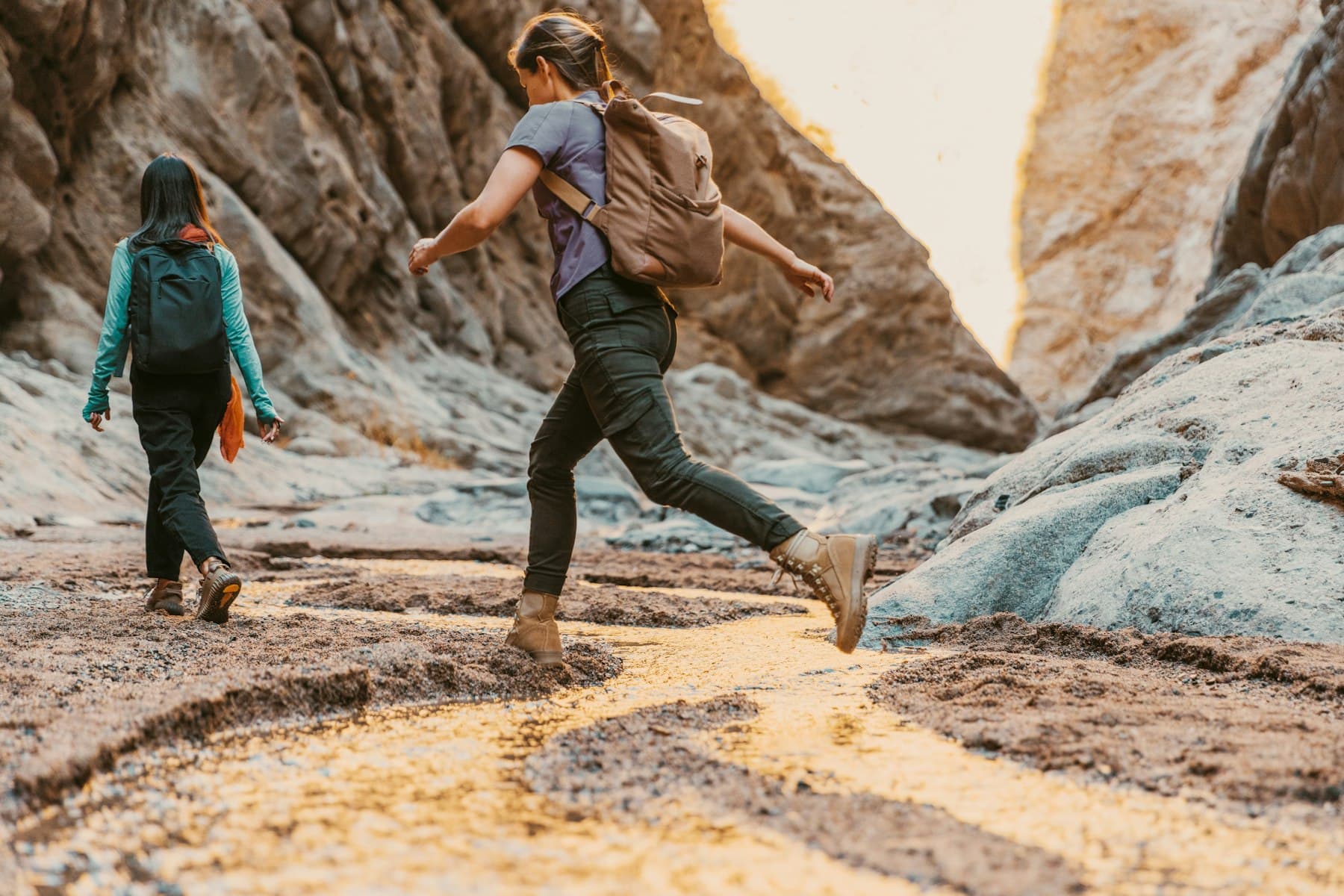 Two active adults hiking outdoors with energy