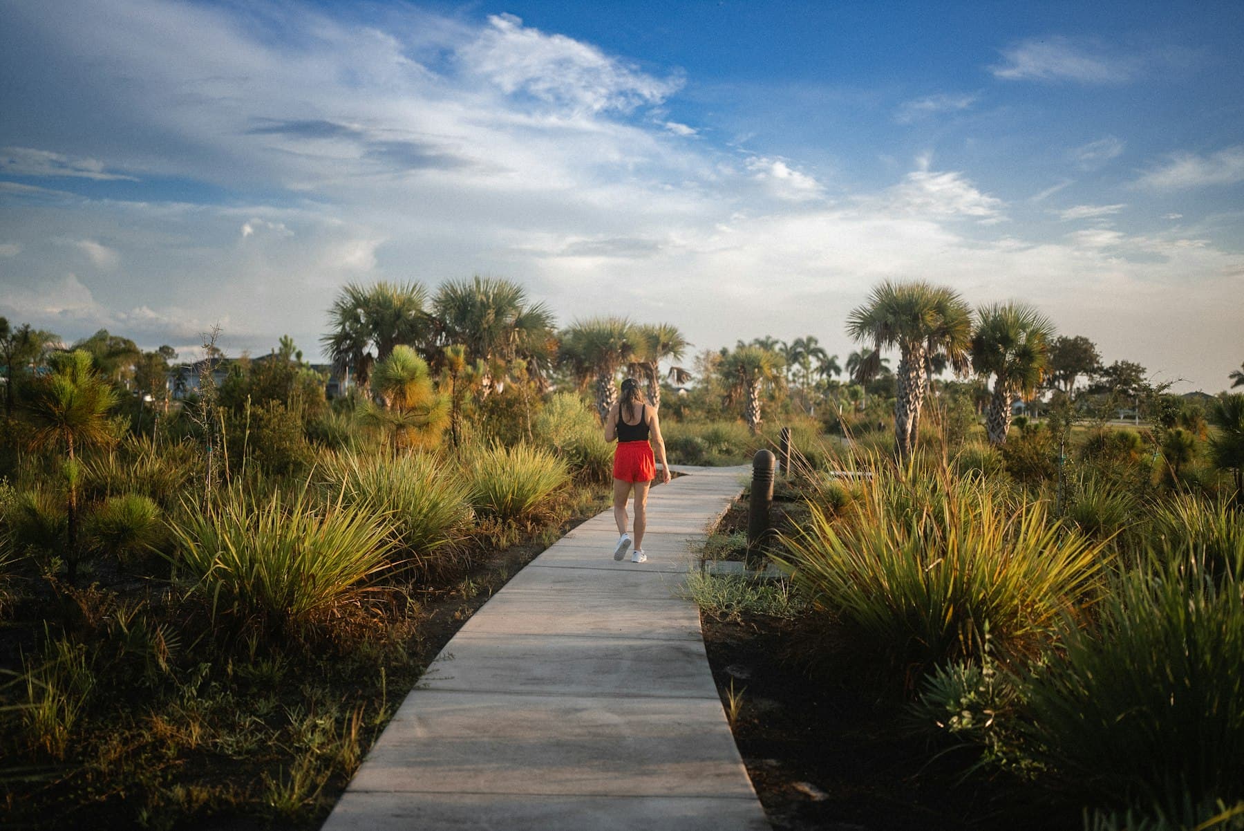 Woman walking outdoors on a sunny path